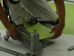 Construction Worker Lays Vinyl Tile Flooring Stock Footage
