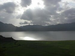 Green landscape with lake and moving clouds Stock Footage
