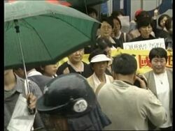 SOUTH KOREA: SEOUL: POLICE STOP WOMAN FROM BURNING EFFIGY News Clip