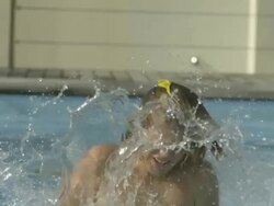 High Speed Water balloon bursts as it hits boy's head, Spain. Stock Footage