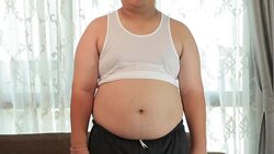 Smiling overweight asian man at home Stock Footage