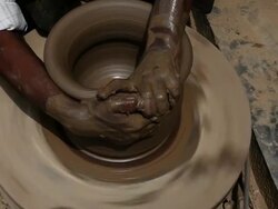 Man making a earthen pot on a pottery wheel  Stock Footage