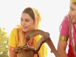 Three young women playing with water near handpump, Haryana, India Stock Footage