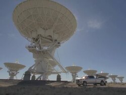 WS Man walking near satellite dishes and truck / San Augustine, New Mexico, USA  Stock Footage