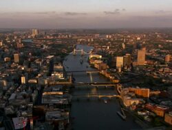 High Angle aerial push-out - An aerial of the River Thames flowing through London transforms into a computer-generated image of the river before settlement. / London, United Kingdom Stock Footage