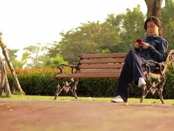 Dolly Shot:Girl play smart phone Stock Footage