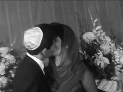 B/W 1959 Elizabeth Taylor + Eddie Fisher in yarmulke kissing after civil ceremony / newsreel Stock Footage