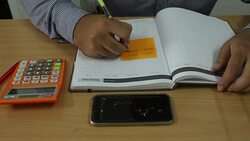 Businessman analyzing data on mobile and take note Stock Footage