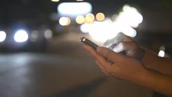 HD:Woman touching smartphone at night time Stock Footage