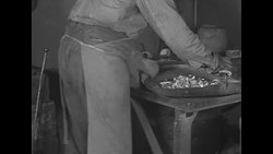 Employee at US Mint in Philadelphia places gold jewelry in furnace to be melted down News Clip