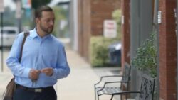 Small business owner walks to work in morning and unlocks restaurant Stock Footage