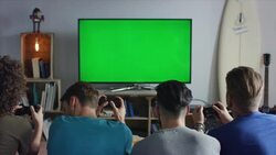 Guys sitting on couch playing video games Stock Footage
