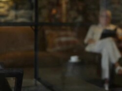 hotel lobby fireplace fire woman book reading coffee holiday vacation resort getaway lodge  Stock Footage