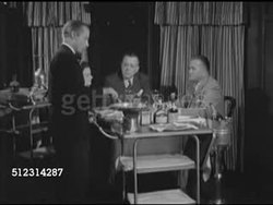 1952: NEW ORLEANS: FRENCH QUARTER: WS Restaurant headwaiter in tuxedo w/ tableside portable cooking cart, liqueurs & brandy for Crepes Suzette (Cointreau, Grand Marnier, Armagnac) sauce, speaking SOT in French to Mrs. Porto, Mr. Nutter, Instructional Video