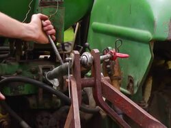 CU SLO MO PAN Shot of hooking up farming equipment up to tractor / Chatham, Michigan, United States Stock Footage
