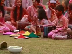 Family celebrating holi festival in the lawn  Stock Footage
