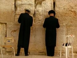 MS, two men praying facing Wailing Wall, Jerusalem, Israel Stock Footage
