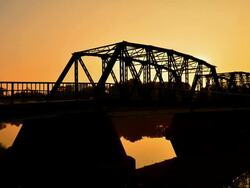 Time-lapse: Steel Bridge at Silhouette Sunset Stock Footage