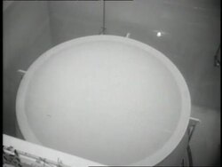 Two men monitor the control room at the first civilian Atomic Power Plant. Stock Footage