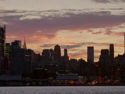 Shot of the Midtown Manhattan Skyline against a blue and purple sky in the late afternoon. The Empire State Building, New York Times Building, H&M Building and Chrysler Building are clearly visible Stock Footage