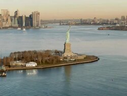 Aerial view of Statue of Liberty in the late afternoon Stock Footage