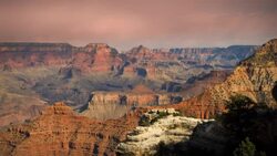 Clouds drift over the Grand Canyon at golden hour. Stock Footage