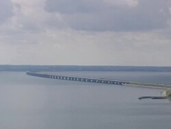 WS AERIAL ZI ZO View of train and cars on Great belt bridge / Fyn, Denmark Stock Footage