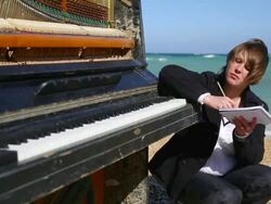 young woman writes on the coast Stock Footage