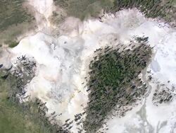 WS AERIAL DS ZI View over Bubbling Pool, fire hole Spring bubbles splashes continuously / Wyoming, United States Stock Footage