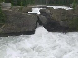 CU Shot of river flowing through trees at Natural Bridge / Yoho Nationalpark, British Columbia, Canada Stock Footage