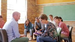 Woman taking notes in group therapy session Stock Footage