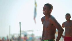 Brazilian player talks to opposing team and laughs on beach footvolley court Stock Footage