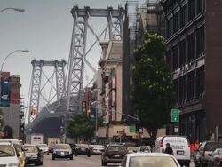 A busy Brooklyn Street with the Manhattan Bridge in the background Stock Footage