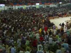 WS PAN Large church interior filling up with people praying, singing and dancing / Lagos, Nigeria Stock Footage