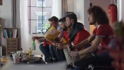 Sport fans sitting on couch watching tv disappointed Stock Footage