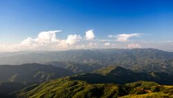 Time lapse of clouds moving over mountain at sunset Stock Footage