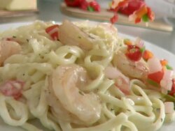 MS POV SLO MO Shrimp alfredo pasta with tomatoes and onions fall onto pasta / Los Angeles, CA, United States Stock Footage