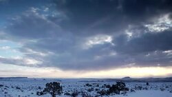 Clouds race above a snowy plain. Stock Footage