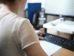 Female office worker at computer Stock Footage