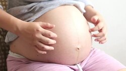 Pregnant woman scratching her belly Stock Footage