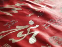 CU POV Red Chinese script on silk fabric / Singapore, Singapore, Singapore Stock Footage