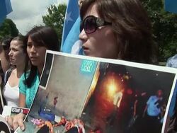 2009 MS PAN TD Protestor shouting slogans and holding photograph of violence in China against the Uygur people during an anti-China protest in support of the Uygurs/ Washington D.C., USA/ AUDIO Stock Footage