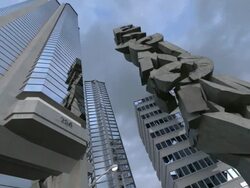 MS Shot of stone tower of stacked letters spelling out word 'ECONOMY' crumbles to ground against cityscape Stock Footage