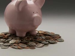 CU, ZO, MS, Studio shot of pink piggy bank pile of coins Stock Footage
