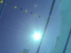 MS SLO MO Shot of Underwater shot, abstract, along under surface of empty pool, looking up at sun, lane line passes / Davis, California, United States   Stock Footage