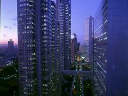 WA Tocho dori street with Shinjuku metropolitan government building, evening, Tokyo, Japan Stock Footage