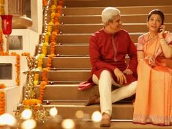Senior couple talking on a mobile phone in diwali festival Stock Footage