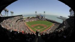 Fans watch a San Fransisco Giants game from behind the home plate at the AT and T Park in San Fransisco. Stock Footage