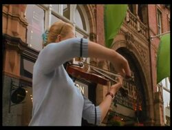 Leeds Town centre, West Yorkshire: violinist busking, Shoppers walking in pedestrianised street. 2007; short sequence. Stock Footage