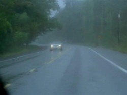 Medium shot car point of view driving along rainy highway Stock Footage